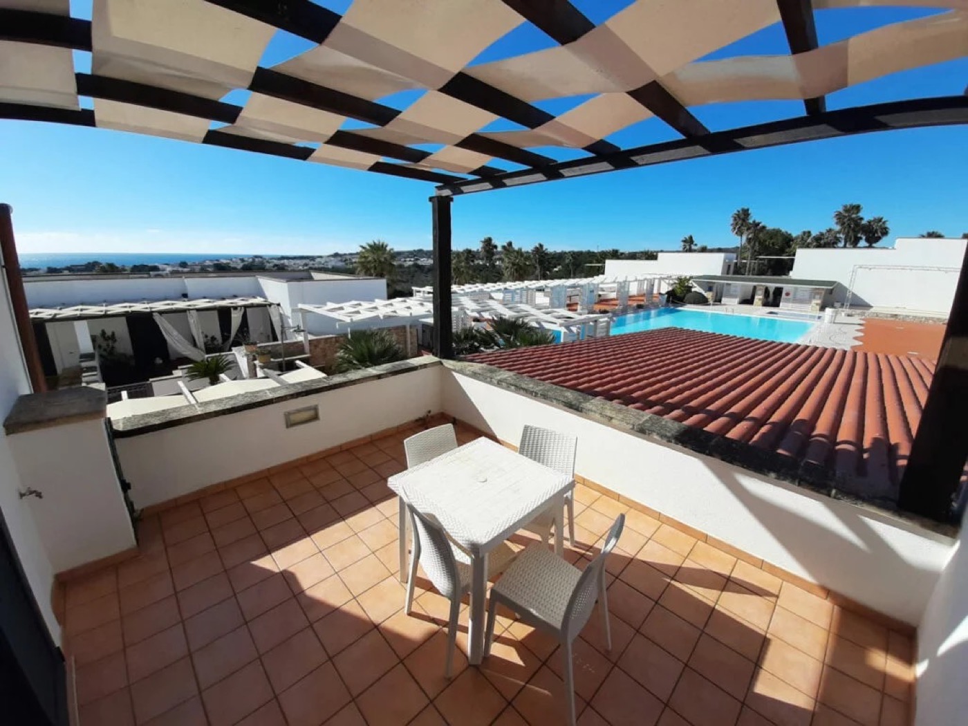 Quadruple room's private terrace overlooking the pool and sea