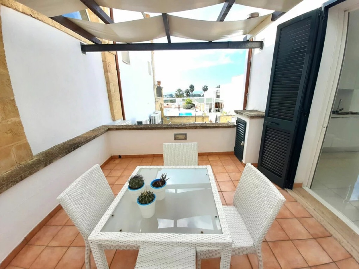 A private sea-view terrace with wicker seating